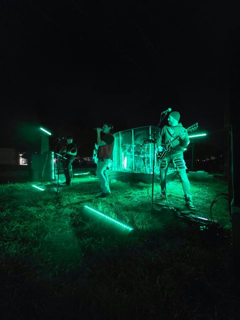 The stage washed green during an outdoor night set